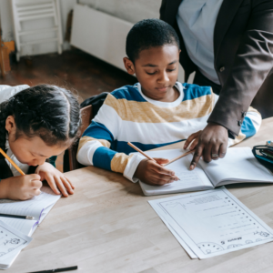 Child sitting at school desk doing class work with accomodations