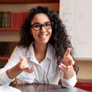 Woman with long hair and glasses is communicating with a person